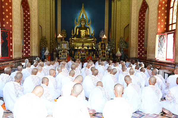 白衣で座る86人の僧侶